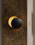 Wall lamp with solar eclipse design