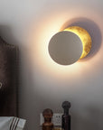 Wall lamp with solar eclipse design